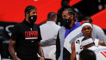 Clippers guard Paul George, left, talks to Kawhi Leonard at a timeout during the second half at the Little Caesars Arena on Wednesday, April 14, 2021.