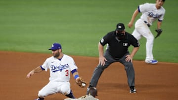 Oct 6, 2020; Arlington, Texas, USA; San Diego Padres right fielder Wil Myers (4) steals second base as Los Angeles Dodgers second baseman Chris Taylor (3) fields the throw during the fourth inning in game one of the 2020 NLDS at Globe Life Field. Mandatory Credit: Tim Heitman-USA TODAY Sports