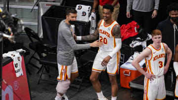 Mar 13, 2021; Atlanta, Georgia, USA; Atlanta Hawks guard Bogdan Bogdanovic (13) and forward John Collins (20) react on the bench near the end of the game against the Sacramento Kings during the second half at State Farm Arena. Mandatory Credit: Dale Zanine-USA TODAY Sports