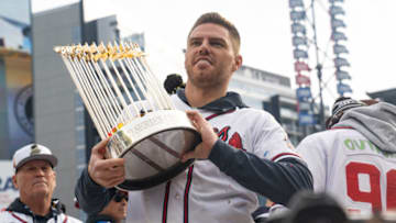 ATLANTA, GA - NOVEMBER 05: Freddie Freeman holds the Commissioner's Trophy as members of the Atlanta Braves celebrate following their World Series Parade at Truist Park on November 5, 2021 in Atlanta, Georgia. The Atlanta Braves won the World Series in six games against the Houston Astros winning their first championship since 1995. (Photo by Megan Varner/Getty Images)