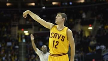 Oct 17, 2014; Cleveland, OH, USA; Cleveland Cavaliers guard Joe Harris (12) follows through on a three-point basket in the fourth quarter against the Dallas Mavericks at Quicken Loans Arena. Mandatory Credit: David Richard-USA TODAY Sports