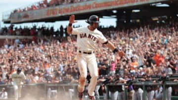Jun 14, 2014; San Francisco, CA, USA; San Francisco Giants center fielder Angel Pagan (16) jumps up after sliding safely home on a sacrifice fly by catcher Buster Posey (not pictured) against the Colorado Rockies during the seventh inning at AT&T Park. Mandatory Credit: Kelley L Cox-USA TODAY Sports