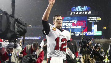 FOXBOROUGH, MASSACHUSETTS - OCTOBER 03: Tom Brady #12 of the Tampa Bay Buccaneers waves to the crowd as he runs off the field after defeating the New England Patriots in the game at Gillette Stadium on October 03, 2021 in Foxborough, Massachusetts. (Photo by Adam Glanzman/Getty Images)