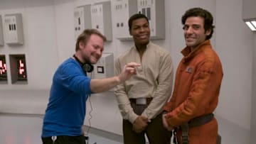 Star Wars: The Last Jedi..L to R: Director Rian Johnson on set with John Boyega (Finn) and Oscar Isaac (Poe Dameron)..Photo: David James..©2017 Lucasfilm Ltd. All Rights Reserved.
