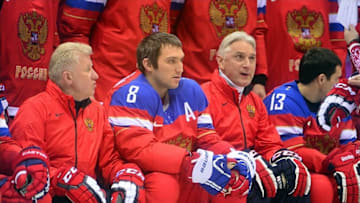 Feb 10, 2014; Sochi, RUSSIA; Russia forward Alex Ovechkin (8) sits between coaches as they wait to take a team photo during a training session in advance of the Sochi 2014 Olympic Winter Games at Bolshoy Arena. Mandatory Credit: Scott Rovak-USA TODAY Sports