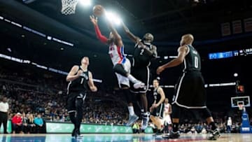 Nov 1, 2014; Auburn Hills, MI, USA; Detroit Pistons forward Greg Monroe (10) goes to the basket against Brooklyn Nets center Kevin Garnett (2) during the game at The Palace of Auburn Hills. Mandatory Credit: Tim Fuller-USA TODAY Sports