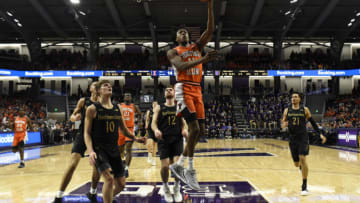 Feb 27, 2020; Evanston, Illinois, USA; Illinois Fighting Illini guard Ayo Dosunmu (11) goes to the basket as Northwestern Wildcats forward Miller Kopp (10) stands nearby during the first half at Welsh-Ryan Arena. Mandatory Credit: David Banks-USA TODAY Sports
