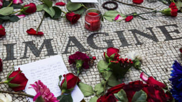 NEW YORK, NY - DECEMBER 08: Memorabilia sits a top the "Strawberry Fields" tile mosaic in Central Park, which was created in tribute to the late musician John Lennon, to mark the 35-year anniversary of his death on December 8, 2015 in New York City. Lennon was shot and killed by a gunman outside his apartment in the nearby Dakota building. (Photo by Andrew Burton/Getty Images)