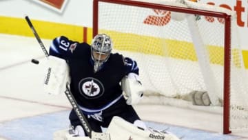 Nov 6, 2014; Winnipeg, Manitoba, CAN; Winnipeg Jets goalie Ondrej Pavelec (31) makes a save during the third period against the Pittsburgh Penguins at MTS Centre. Pittsburgh wins 4-3 overtime. Mandatory Credit: Bruce Fedyck-USA TODAY Sports