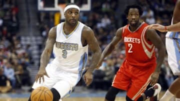 Mar 7, 2015; Denver, CO, USA; Denver Nuggets guard Ty Lawson (3) drives to the basket past Houston Rockets guard Patrick Beverley (2) during the first half at Pepsi Center. Mandatory Credit: Chris Humphreys-USA TODAY Sports