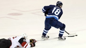 Jan 26, 2016; Winnipeg, Manitoba, CAN; Winnipeg Jets center Bryan Little (18) has a breakaway during the second period against the Arizona Coyotes at MTS Centre. Mandatory Credit: Bruce Fedyck-USA TODAY Sports
