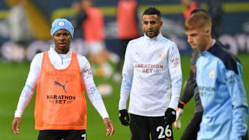 Manchester City's English midfielder Raheem Sterling (L) and Manchester City's Algerian midfielder Riyad Mahrez (C) warm up ahead of the English Premier League football match between Leeds United and Manchester City at Elland Road in Leeds, northern England on October 3, 2020. (Photo by Paul ELLIS / POOL / AFP) / RESTRICTED TO EDITORIAL USE. No use with unauthorized audio, video, data, fixture lists, club/league logos or 'live' services. Online in-match use limited to 120 images. An additional 40 images may be used in extra time. No video emulation. Social media in-match use limited to 120 images. An additional 40 images may be used in extra time. No use in betting publications, games or single club/league/player publications. / (Photo by PAUL ELLIS/POOL/AFP via Getty Images)