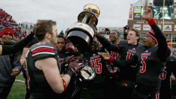 LOUISVILLE, KY - NOVEMBER 29: Louisville Cardinals hold the Governor"s Cup after the 44-40 win over the Kentucky Wildcats at Papa John's Cardinal Stadium on November 29, 2014 in Louisville, Kentucky. (Photo by Andy Lyons/Getty Images)