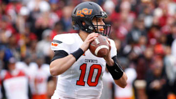 NORMAN, OK - DECEMBER 6: Quarterback Mason Rudolph #10 of the Oklahoma State Cowboys looks to throw against the Oklahoma Sooners December 6, 2014 at Gaylord Family-Oklahoma Memorial Stadium in Norman, Oklahoma. The Cowboys defeated the Sooners 38-35 in overtime. (Photo by Brett Deering/Getty Images)