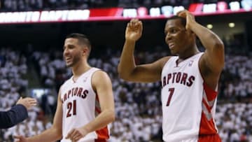 Apr 30, 2014; Toronto, Ontario, CAN; Toronto Raptors guard Greivis Vasquez (21) and Toronto Raptors guard Kyle Lowry (7) react after a play against the Brooklyn Nets in game five of the first round of the 2014 NBA Playoffs at the Air Canada Centre. Toronto defeated Brooklyn 115-113. Mandatory Credit: John E. Sokolowski-USA TODAY Sports