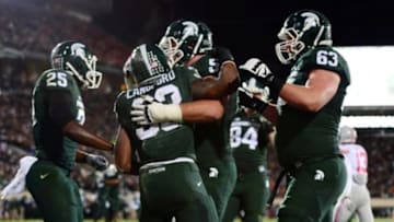 Nov 8, 2014; East Lansing, MI, USA; Michigan State Spartans running back Jeremy Langford (33) celebrates after scoring a touchdown during the first quarter against the Ohio State Buckeyes at Spartan Stadium. Mandatory Credit: Andrew Weber-USA TODAY Sports