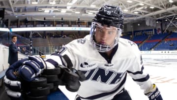 DURHAM, NH - NOVEMBER 01: Angus Crookshank #9 of the New Hampshire Wildcats knocks the pucks to the ice before a game against the Boston College Eagles during NCAA men's hockey at the Whittemore Center on November 1, 2019 in Durham, New Hampshire. The Wildcats won 1-0 in overtime on a goal by Crookshank (Photo by Richard T Gagnon/Getty Images)