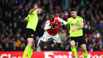 LONDON, ENGLAND - JANUARY 18: Nicolas Pepe of Arsenal is tackled by Enda Stevens of Sheffield United during the Premier League match between Arsenal FC and Sheffield United at Emirates Stadium on January 18, 2020 in London, United Kingdom. (Photo by Clive Mason/Getty Images)