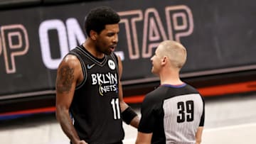 NEW YORK, NEW YORK - APRIL 10: Kyrie Irving #11 of the Brooklyn Nets reacts after he is issued a double technical foul and ejected from the game in the third quarter by referee Tyler Ford #39 at Barclays Center on April 10, 2021 in the Brooklyn borough of New York City.NOTE TO USER: User expressly acknowledges and agrees that, by downloading and or using this photograph, User is consenting to the terms and conditions of the Getty Images License Agreement. (Photo by Elsa/Getty Images)