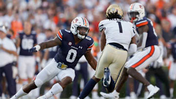 Auburn footballSep 4, 2021; Auburn, Alabama, USA; Auburn Tigers linebacker Owen Pappoe (0) closes in on Akron Zips quarterback Kato Nelson (1) during the first quarter at Jordan-Hare Stadium. Mandatory Credit: John Reed-USA TODAY Sports