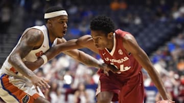 Mar 10, 2016; Nashville, TN, USA; Arkansas guard Jimmy Whitt (24) is guarded by Florida guard Kasey Hill (0) during the SEC basketball tournament at Bridgestone Arena. Mandatory Credit: Andrew Nelles/The Tennessean via USA TODAY NETWORK