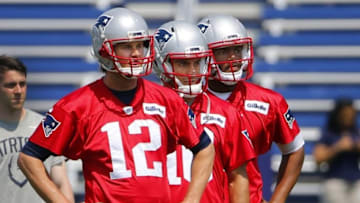 May 26, 2016; Foxborough, MA, USA; New England Patriots quarterback Tom Brady (12), quarterback Jimmy Garoppolo (10) and rookie quarterback Jacoby Brissett (7) look on during OTA