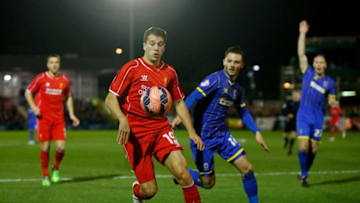 KINGSTON UPON THAMES, ENGLAND - JANUARY 05: Javi Manquillo of Liverpool controls the ball as Callum Kennedy of AFC Wimbledon closes in during the FA Cup Third Round match between AFC Wimbledon and Liverpool at The Cherry Red Records Stadium on January 5, 2015 in Kingston upon Thames, England. (Photo by Julian Finney/Getty Images)