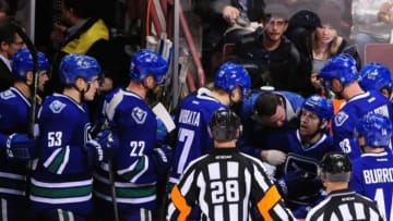 Dec 20, 2014; Vancouver, British Columbia, CAN; Vancouver Canucks forward Jannik Hansen (36) is attended to on the bench during the second period against the Calgary Flames at Rogers Arena. Mandatory Credit: Anne-Marie Sorvin-USA TODAY Sports