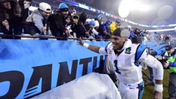Jan 3, 2015; Charlotte, NC, USA; Carolina Panthers quarterback Cam Newton (1) celebrates with fans after beating the Arizona Cardinals in the 2014 NFC Wild Card playoff football game at Bank of America Stadium. Mandatory Credit: Bob Donnan-USA TODAY Sports