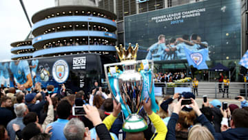 MANCHESTER, ENGLAND - APRIL 22: Manchester City fans pose with a replica trophy during the Premier League match between Manchester City and Swansea City at Etihad Stadium on April 22, 2018 in Manchester, England. (Photo by Clive Brunskill/Getty Images)