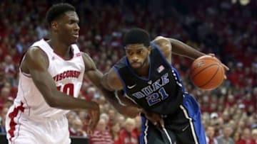 Dec 3, 2014; Madison, WI, USA; Duke Blue Devils forward Amile Jefferson (21) attempts to drive the ball past Wisconsin Badgers forward Nigel Hayes (10) during the first half at the Kohl Center. Mandatory Credit: Mary Langenfeld-USA TODAY Sports