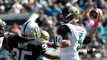 JACKSONVILLE, FL - OCTOBER 23: Blake Bortles #5 of the Jacksonville Jaguars gets set to pass as he's pressured by Jihad Ward #95 of the Oakland Raiders during the game at EverBank Field on October 23, 2016 in Jacksonville, Florida. (Photo by Sam Greenwood/Getty Images)