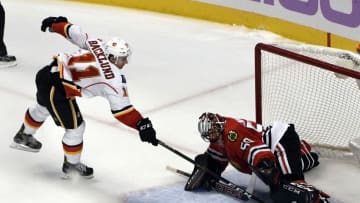 Oct 24, 2016; Chicago, IL, USA; Chicago Blackhawks goalie Corey Crawford (50) makes a save on Calgary Flames center Mikael Backlund (11) during a shootout at the United Center. The Flames won 3-2 in a shootout. Mandatory Credit: David Banks-USA TODAY Sports