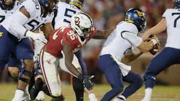 West Virginia's Jarret Doege (2) gets past Oklahoma's Isaiah Thomas (95) during a college football game between the University of Oklahoma Sooners (OU) and the West Virginia Mountaineers at Gaylord Family-Oklahoma Memorial Stadium in Norman, Okla., Saturday, Sept. 25, 2021. Oklahoma won 16-13.Lx12631