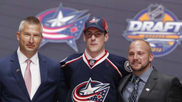 Jun 24, 2016; Buffalo, NY, USA; Pierre-Luc Dubois poses for a photo with team officials after being selected as the number three overall draft pick by the Columbus Blue Jackets in the first round of the 2016 NHL Draft at the First Niagra Center. Mandatory Credit: Timothy T. Ludwig-USA TODAY Sports