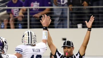 ARLINGTON, TX - OCTOBER 28: Riley Nelson #13 of the BYU Cougars gives the referee a high five after scoring during a game against the TCU Horned Frogs at Cowboys Stadium on October 28, 2011 in Arlington, Texas. The TCU Horned Frogs defeated the BYU Cougars 38-28. (Photo by Sarah Glenn/Getty Images)