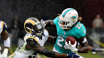 Nov 20, 2016; Los Angeles, CA, USA; Los Angeles Rams middle linebacker Alec Ogletree (52) tackles Miami Dolphins running back Jay Ajayi (23) during the first half of a NFL football game at Los Angeles Memorial Coliseum. Mandatory Credit: Kirby Lee-USA TODAY Sports
