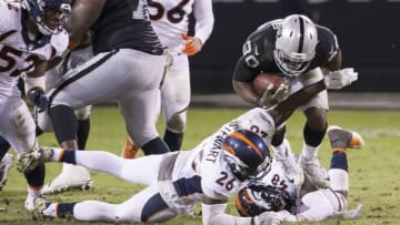 Nov 6, 2016; Oakland, CA, USA; Oakland Raiders running back Jalen Richard (30) is tackled by Denver Broncos free safety Darian Stewart (26) during the fourth quarter at Oakland Coliseum. Mandatory Credit: Neville E. Guard-USA TODAY Sports