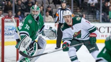 Jan 21, 2014; Dallas, TX, USA; Minnesota Wild right wing Justin Fontaine (14) looks for the puck as Dallas Stars goalie Kari Lehtonen (32) defends during the game at the American Airlines Center. The Stars shut out the Wild 4-0. Mandatory Credit: Jerome Miron-USA TODAY Sports
