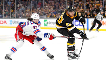 BOSTON, MASSACHUSETTS - NOVEMBER 29: David Pastrnak #88 of the Boston Bruins takes a shot with pressure from Mika Zibanejad #93 of the New York Rangers during the first period at TD Garden on November 29, 2019 in Boston, Massachusetts. (Photo by Maddie Meyer/Getty Images)
