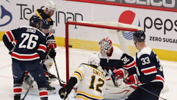 Apr 8, 2021; Washington, District of Columbia, USA; Boston Bruins center Craig Smith (12) scores a goal on Washington Capitals goaltender Ilya Samsonov (30) in the third period at Capital One Arena. Mandatory Credit: Geoff Burke-USA TODAY Sports