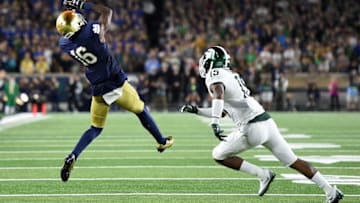 SOUTH BEND, IN - SEPTEMBER 17: Torii Hunter Jr. #16 of the Notre Dame Fighting Irish catches a pass in front of Tyson Smith #15 of the Michigan State Spartans during a game at Notre Dame Stadium on September 17, 2016 in South Bend, Indiana. Michigan State defeated Notre Dame 36-28. (Photo by Stacy Revere/Getty Images)