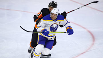 Apr 11, 2021; Philadelphia, Pennsylvania, USA; Buffalo Sabres right wing Kyle Okposo (21) skates past Philadelphia Flyers defenceman Shayne Gostisbehere (53) in the first period at Wells Fargo Center. Mandatory Credit: Kyle Ross-USA TODAY Sports