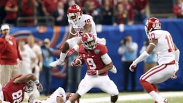Jan 2, 2014; New Orleans, LA, USA; Alabama Crimson Tide wide receiver Amari Cooper (9) carries the ball in front of Oklahoma Sooners linebacker Eric Striker (19)in the first half at the Mercedes-Benz Superdome. Mandatory Credit: Crystal LoGiudice-USA TODAY Sports