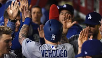 PHOENIX, AZ - MAY 02: Alex Verdugo #61 of the Los Angeles Dodgers celebrates with teammates in the dugout after scoring a run against the Arizona Diamondbacks during the eighth inning at Chase Field on May 2, 2018 in Phoenix, Arizona. (Photo by Norm Hall/Getty Images)