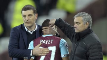 STRATFORD, ENGLAND - JANUARY 02: Dimitri Payet (C) of West Ham United is given a hug by manager Slaven Bilic and a pat on the head from Jose Mourinho of Manchester United during the Premier League match between West Ham United and Manchester United at London Stadium on January 2, 2017 in Stratford, England. (Photo by Arfa Griffiths/West Ham United via Getty Images)