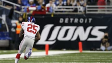 Dec 22, 2013; Detroit, MI, USA; New York Giants free safety Will Hill (25) makes an interception for a touchdown during the fourth quarter against the Detroit Lions at Ford Field. Giants beat the Lions 23-20. Mandatory Credit: Raj Mehta-USA TODAY Sports