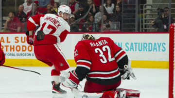 Apr 14, 2022; Raleigh, North Carolina, USA; Carolina Hurricanes goaltender Antti Raanta (32) stops Detroit Red Wings defenseman Filip Hronek (17) shot during the second period at PNC Arena. Mandatory Credit: James Guillory-USA TODAY Sports