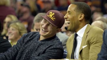 Oct 30, 2014; Cleveland, OH, USA; Cleveland Browns quarterback Johnny Manziel (left) laughs with Maverick Carter of LRMR Management in the second quarter at Quicken Loans Arena. Mandatory Credit: David Richard-USA TODAY Sports