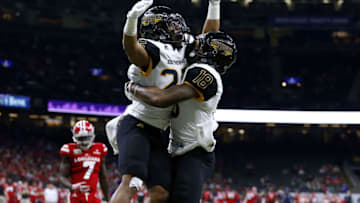 NEW ORLEANS, LA - DECEMBER 17: Ito Smith #25 of the Southern Miss Golden Eagles celebrates a touchdown with Korey Robertson #18 during the first half of a game against the Louisiana-Lafayette Ragin Cajuns at the Mercedes-Benz Superdome on December 17, 2016 in New Orleans, Louisiana. (Photo by Jonathan Bachman/Getty Images)